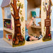 Treehouse Reading Nook - WB1531 – kid seated inside reaching toward a book on an interior shelf