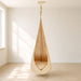 Wood and Hearts Pod Swing – Warm Honey hanging pod and seat opening in a room